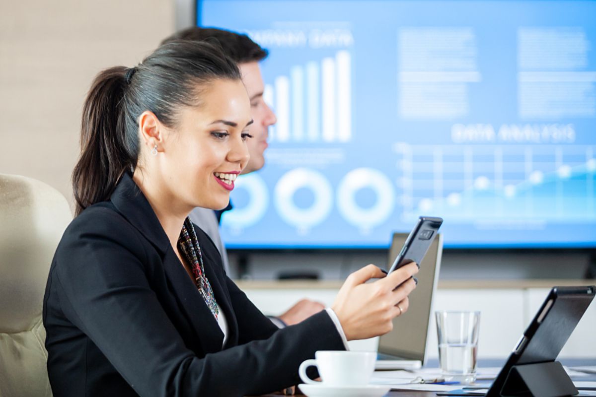 A businesswoman checking work updates with the help of a ERP solution