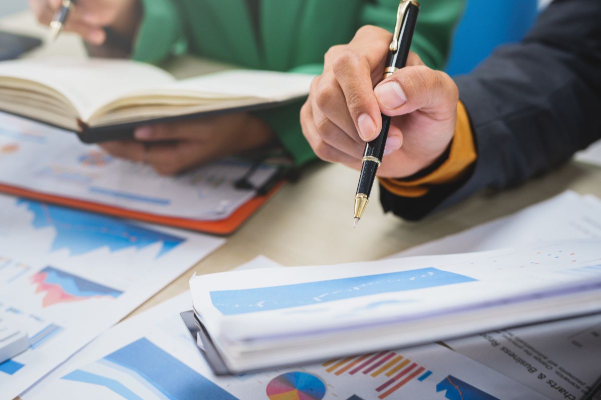 An accounting team looking at hand-written data