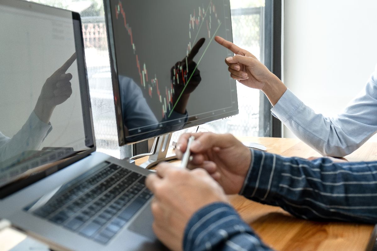 Two professionals analyzing business impact with reports from ERP software