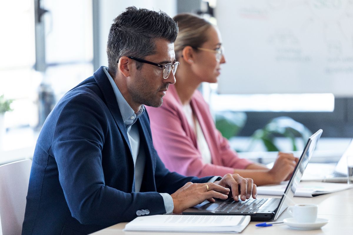 A business professioal concentratd on work on laptop using an ERP solutions