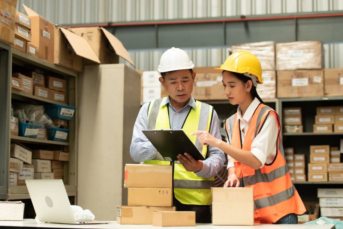 workers in warehouse using software to streamline operations