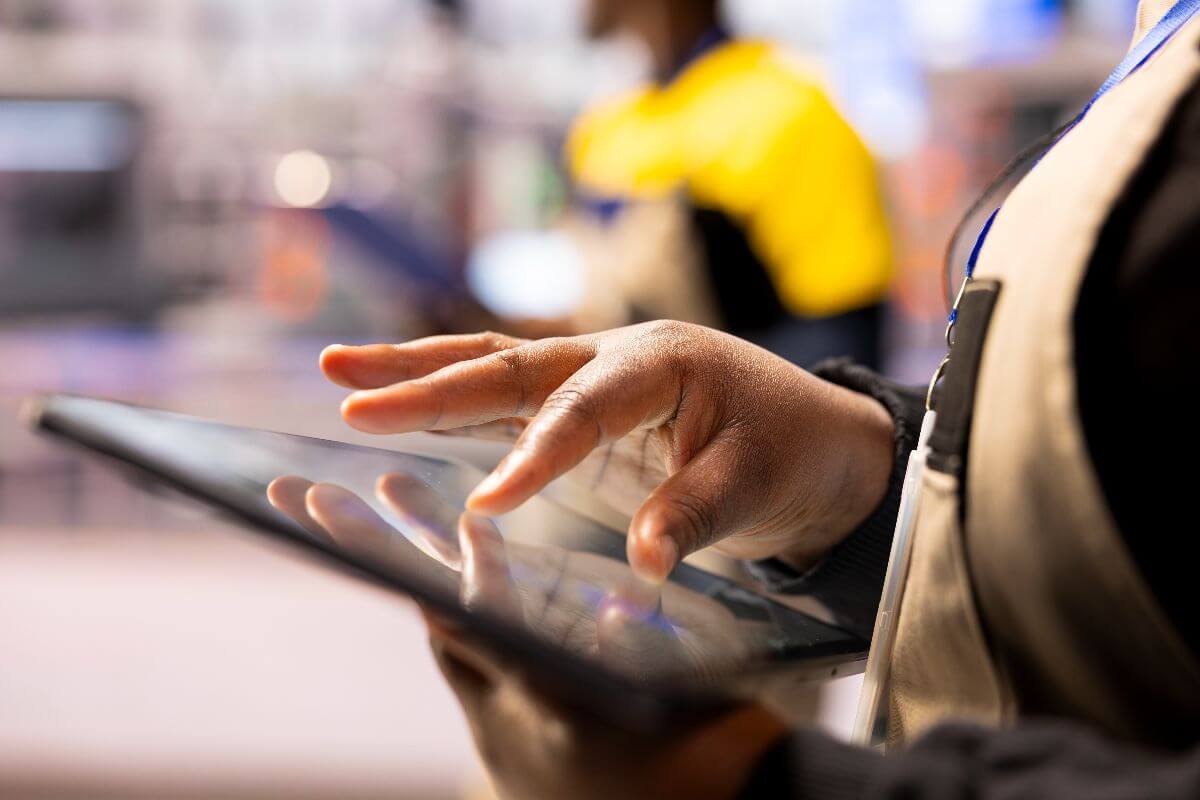 hand working on tablet in a warehouse