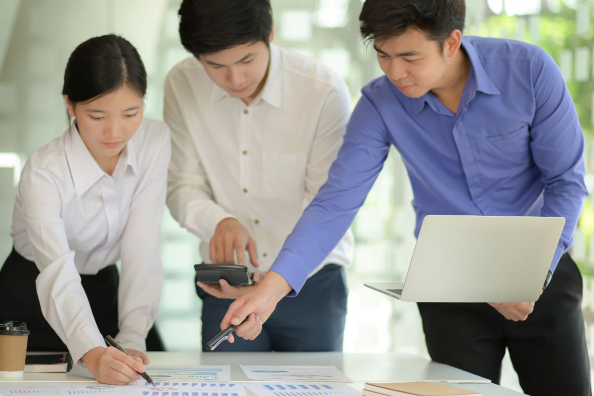 Business team reviewing charts and reports together, representing e-commerce planning and operational decision-making.
