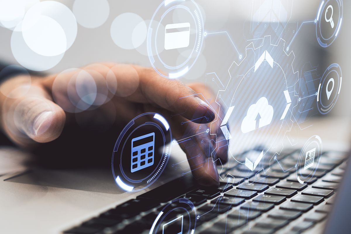 Digital accounting and compliance icons over a laptop keyboard representing BIR CAS accreditation and financial system readiness