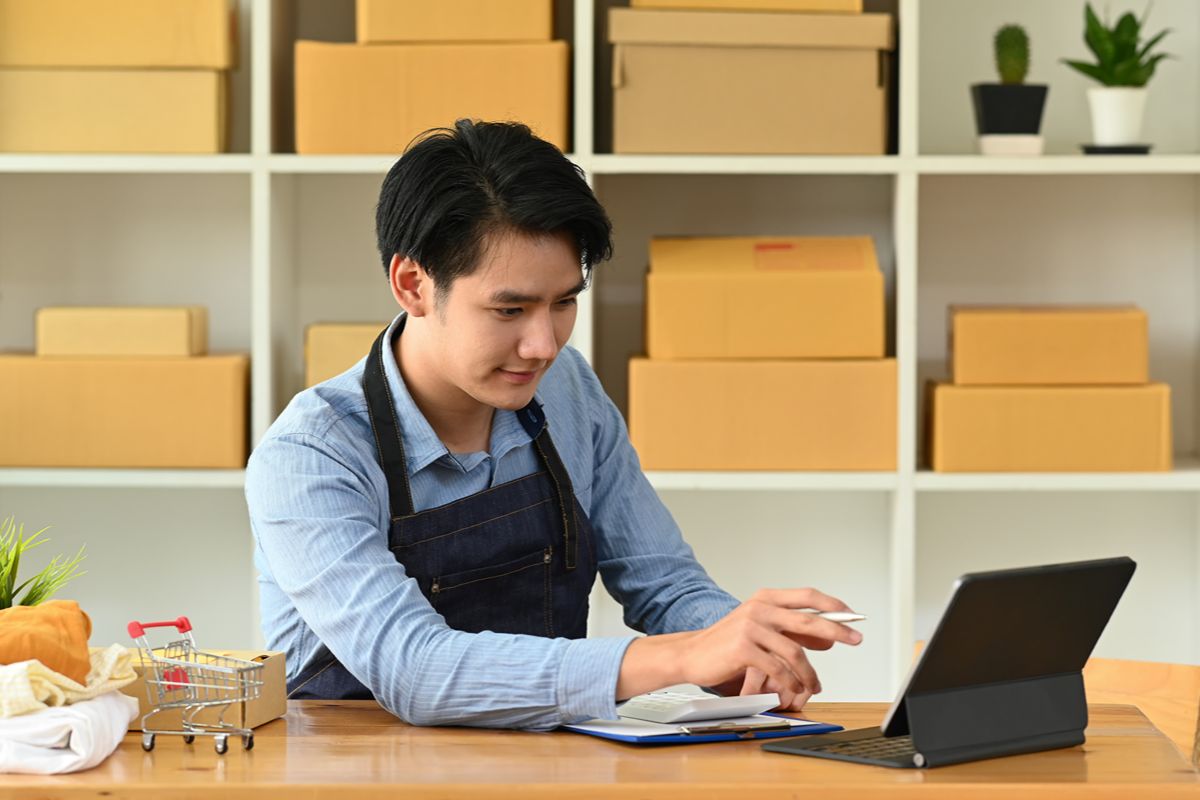 Warehouse worker using a tablet to manage orders and inventory