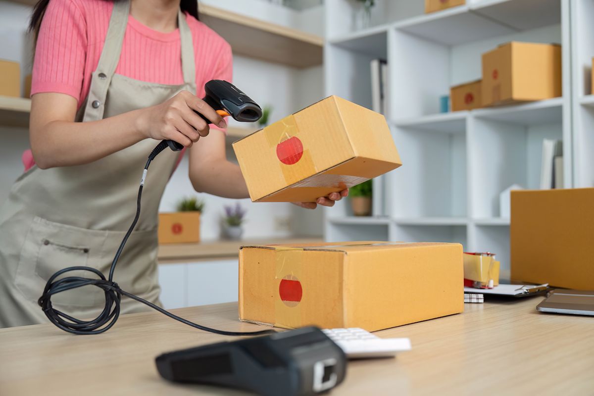 Worker scanning a package barcode during warehouse inventory processing