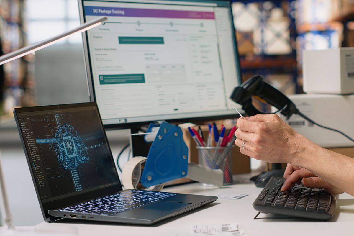 Employee using a barcode scanner with connected computer systems for product tracking