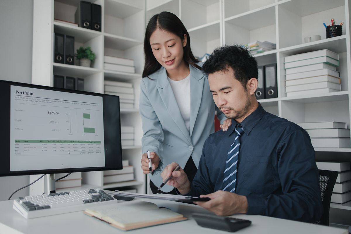 Finance professionals reviewing financial data on accounting software