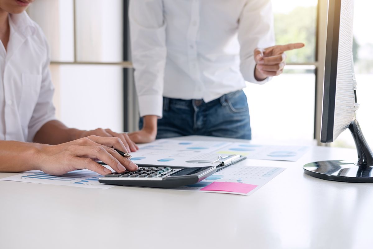 business professionals reviewing financial records and calculations for BIR compliance