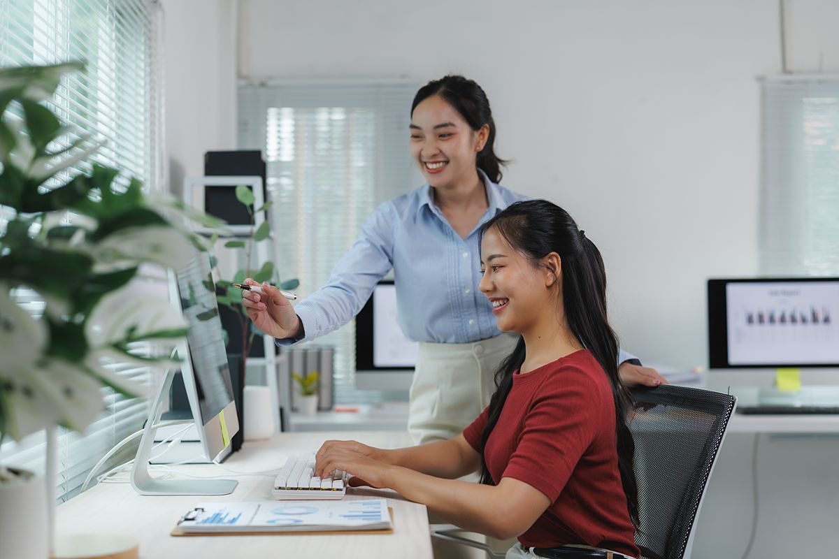 office colleagues reviewing digital records on a computer